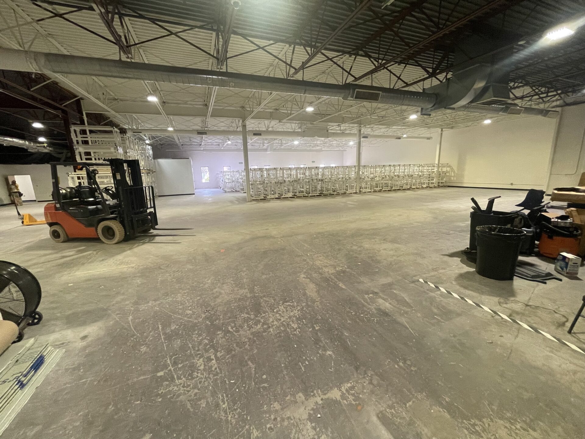 Inside of an empty warehouse with forklift.